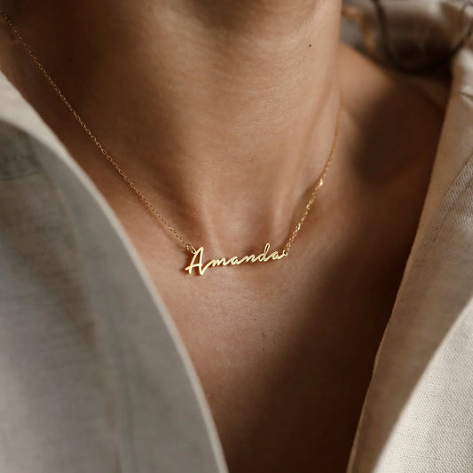 Minimal Script Name Necklace in 18K gold finish on neckline, personalized cursive name pendant with delicate chain, elegant everyday jewelry by Aishwaryam Jewel
